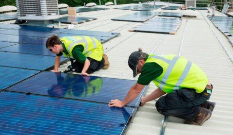 photovoltaic solar panels being installed on a roof